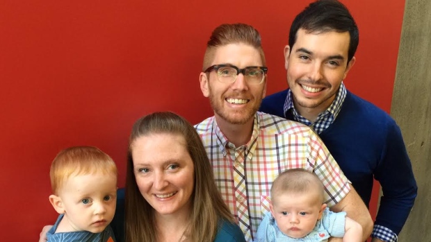 Craig Parkes (right) and Matthew Hinton were able to have their son, Fitzgerald, thanks to Matt's sister Laura agreeing to act as a surrogate. 